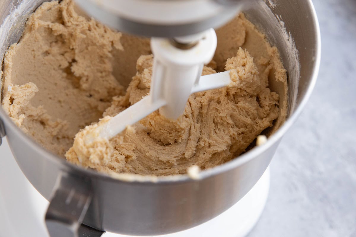 Snickerdoodle cookie dough in a stand mixer.