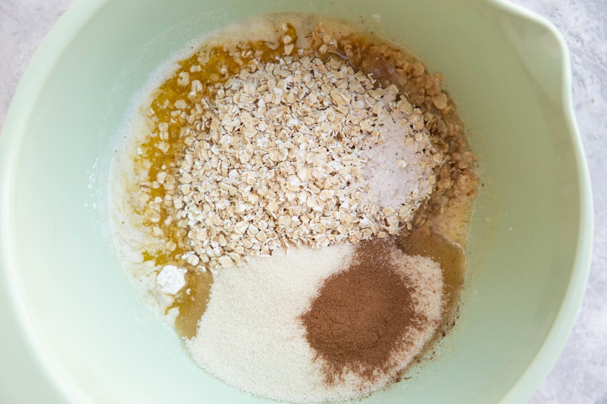 Crumble topping mixture in a mixing bowl, to be mixed together.