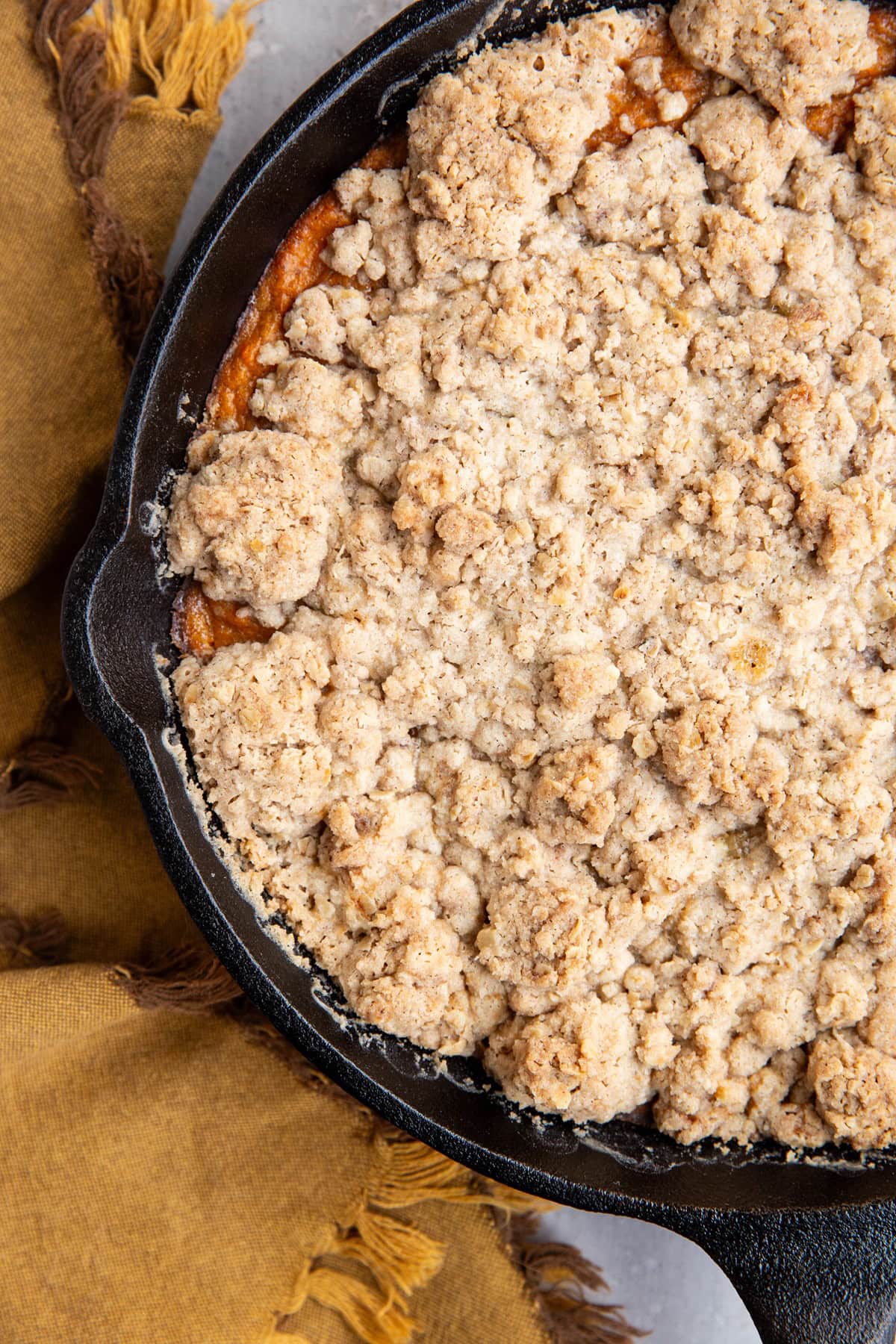 Sweet potato crumble in a cast iron skillet, ready to serve fresh out of the oven.