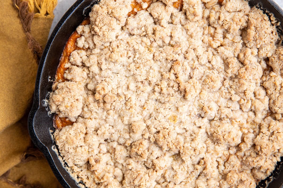 Cast iron skillet of sweet potato crumble for Thanksgiving dessert.