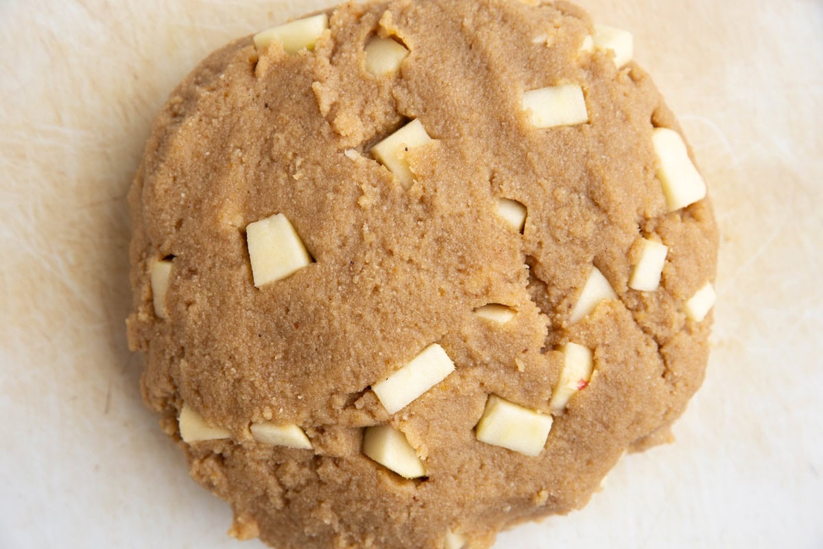 Scone dough shaped into a disc shape on a cutting board.