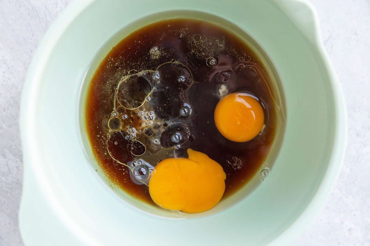 Eggs, pure maple syrup, and avocado oil in a mixing bowl to make gluten free scones.