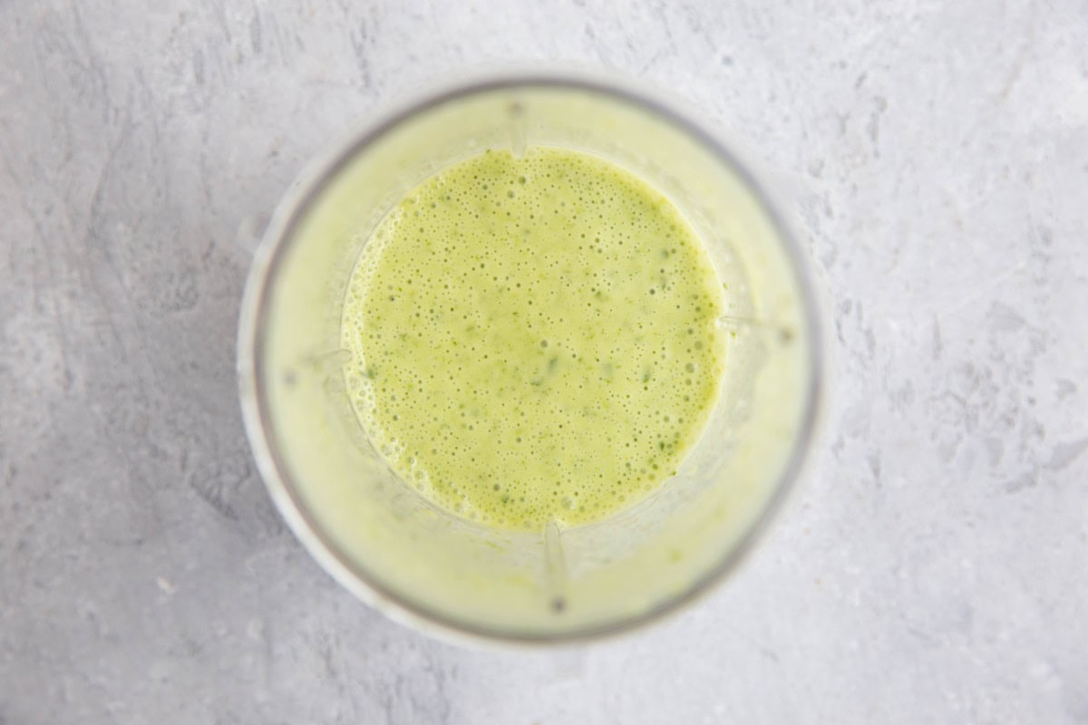 Small blender full of lemon parsley dressing to use in salad