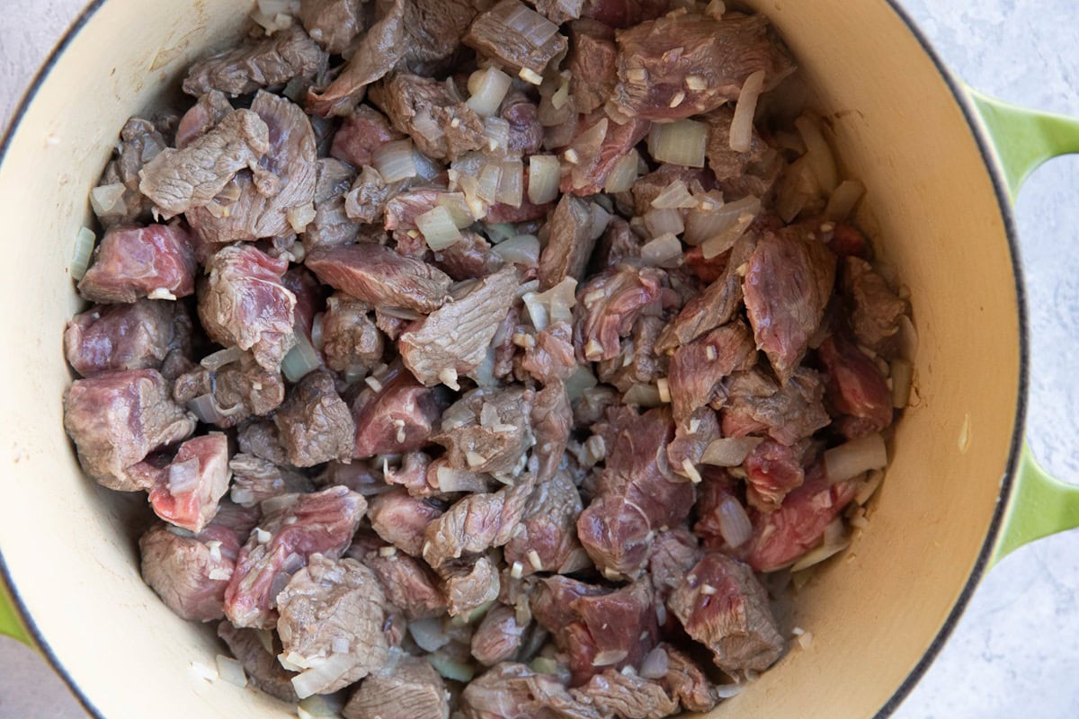 Browned beef and onions in a large pot.