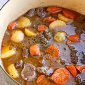 Big pot of beef stew with carrots and potatoes. Ready to serve.