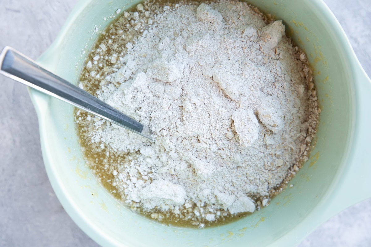 Flour on top of wet ingredients in a mixing bowl.