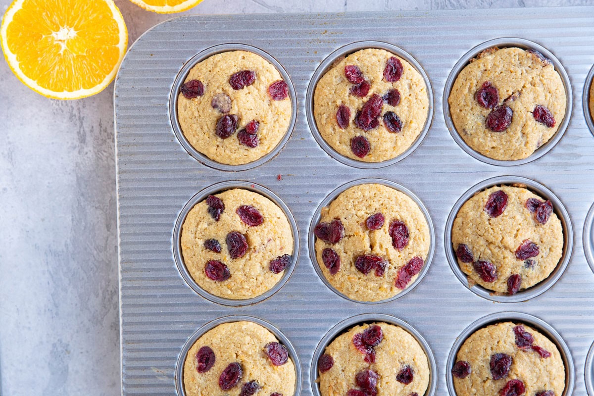 Cranberry orange muffins in a muffin tin.