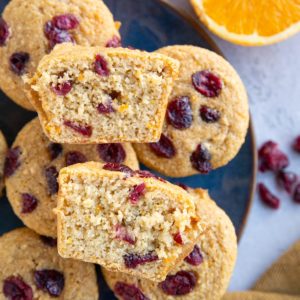 Blue plate full of cranberry orange muffins.