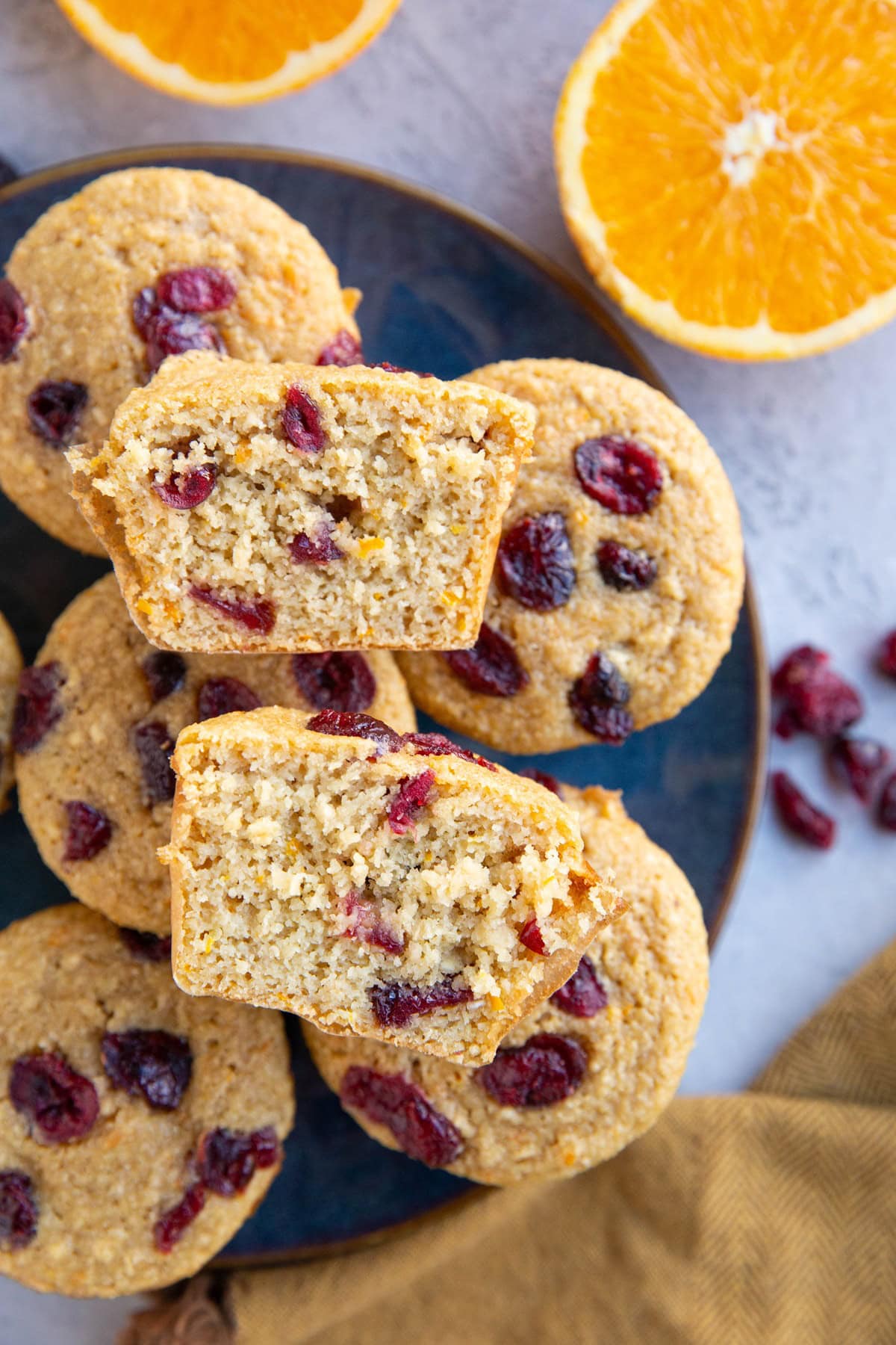 Blue plate full of cranberry orange muffins.