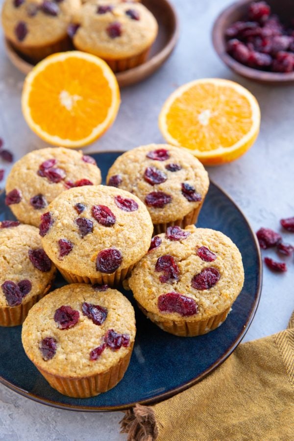 Blue plate of cranberry orange muffins.