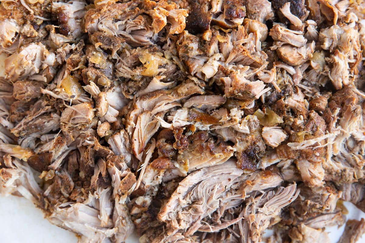 Shredded pork on a cutting board.