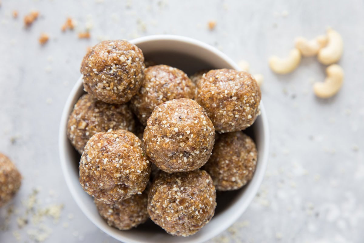 White bowl full of energy bites made with healthy ingredients.