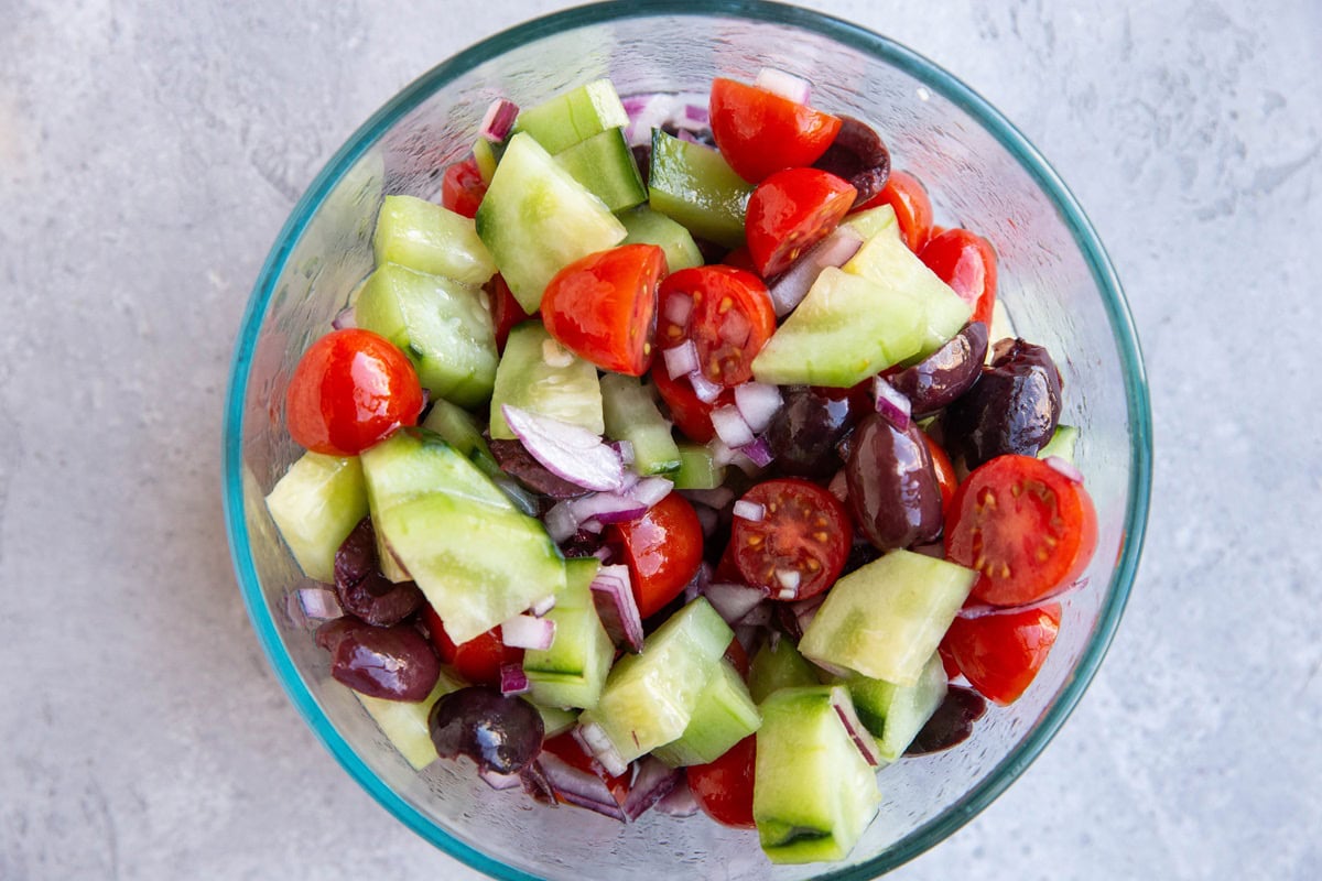 Tomato cucumber salad in a bowl, ready to serve.