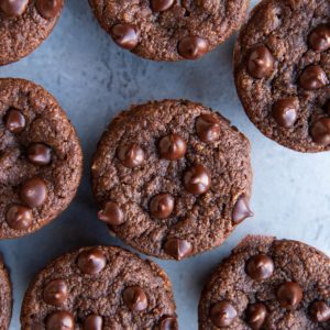 Chocolate muffins on a blue background, fresh out of the oven and ready to eat.