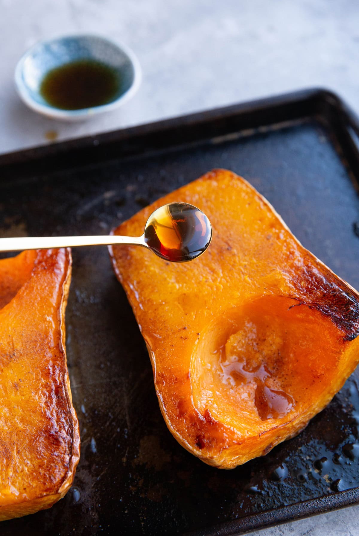 Drizzling butternut squash with pure maple syrup.