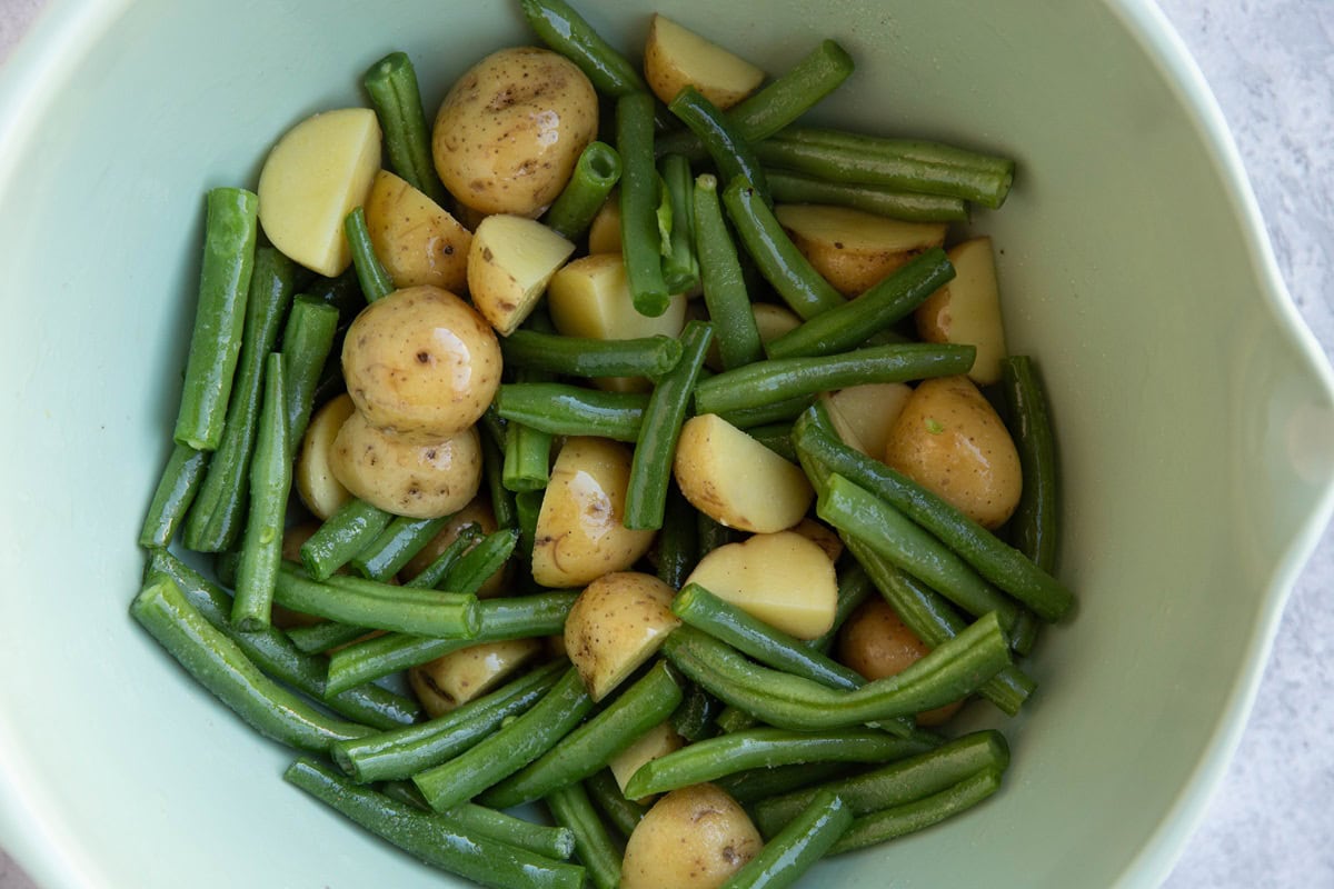 Green beans and potatoes in a mixing bowl.