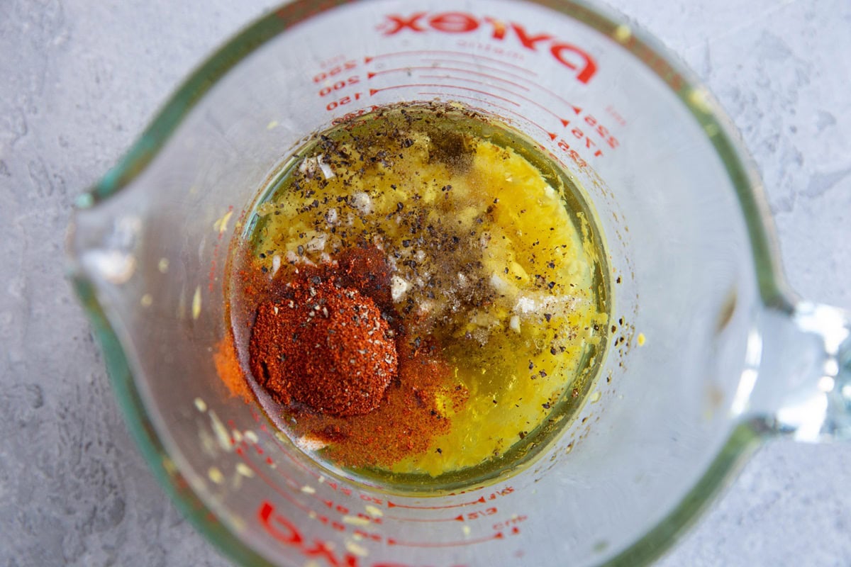 Marinade ingredients in a measuring cup.