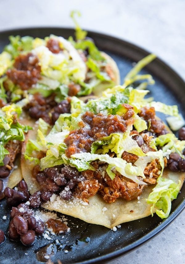 Black plate full of chicken tostadas