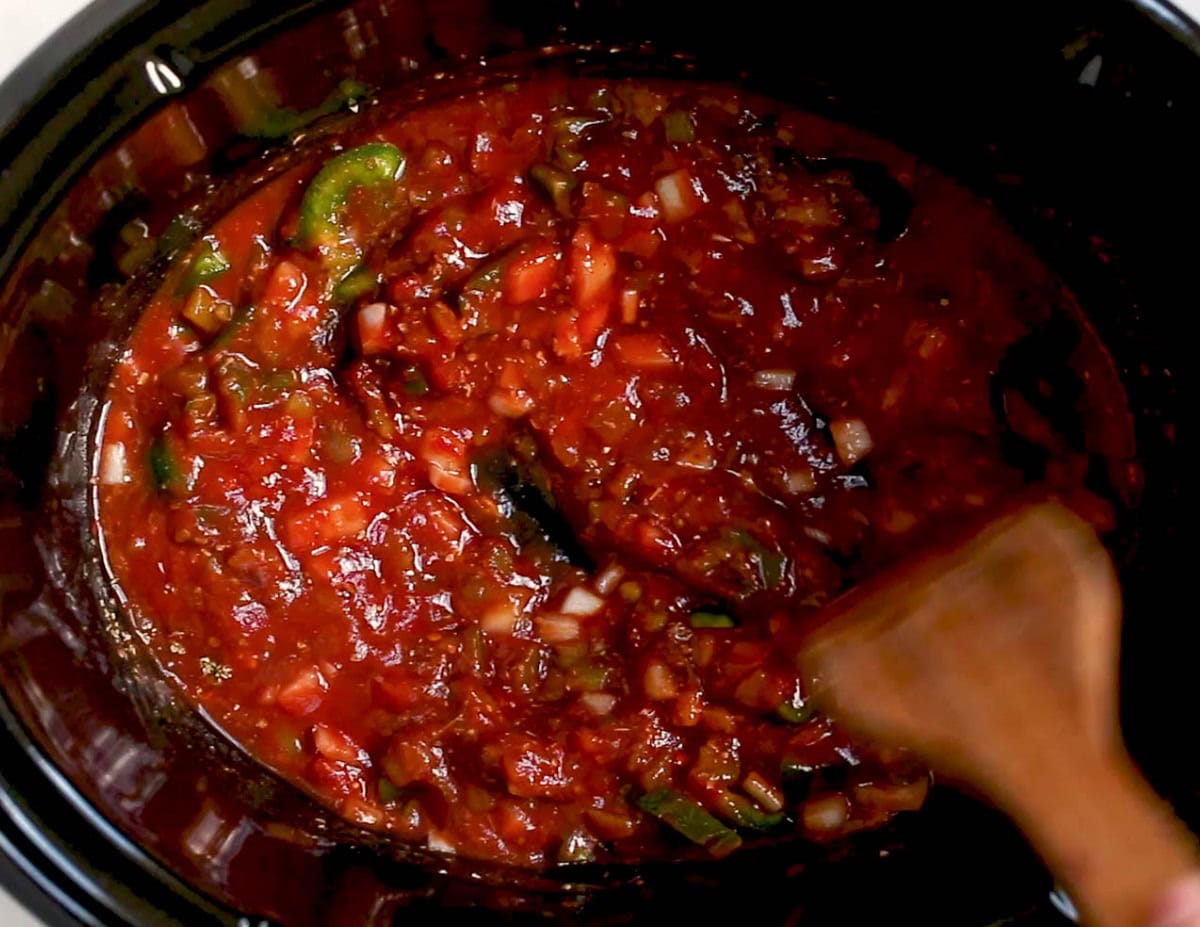 Slow cooker with sauce mixture inside.