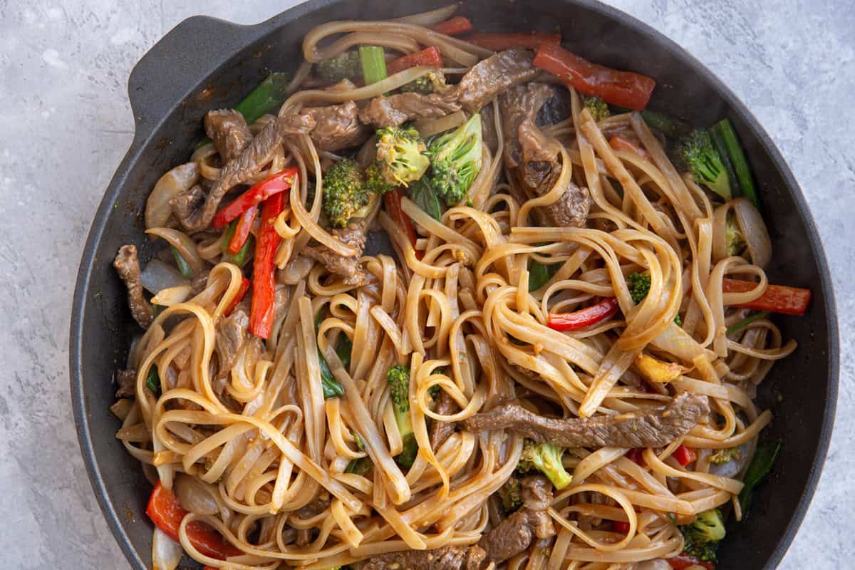 Large skillet with noodles, beef and vegetables, ready to serve