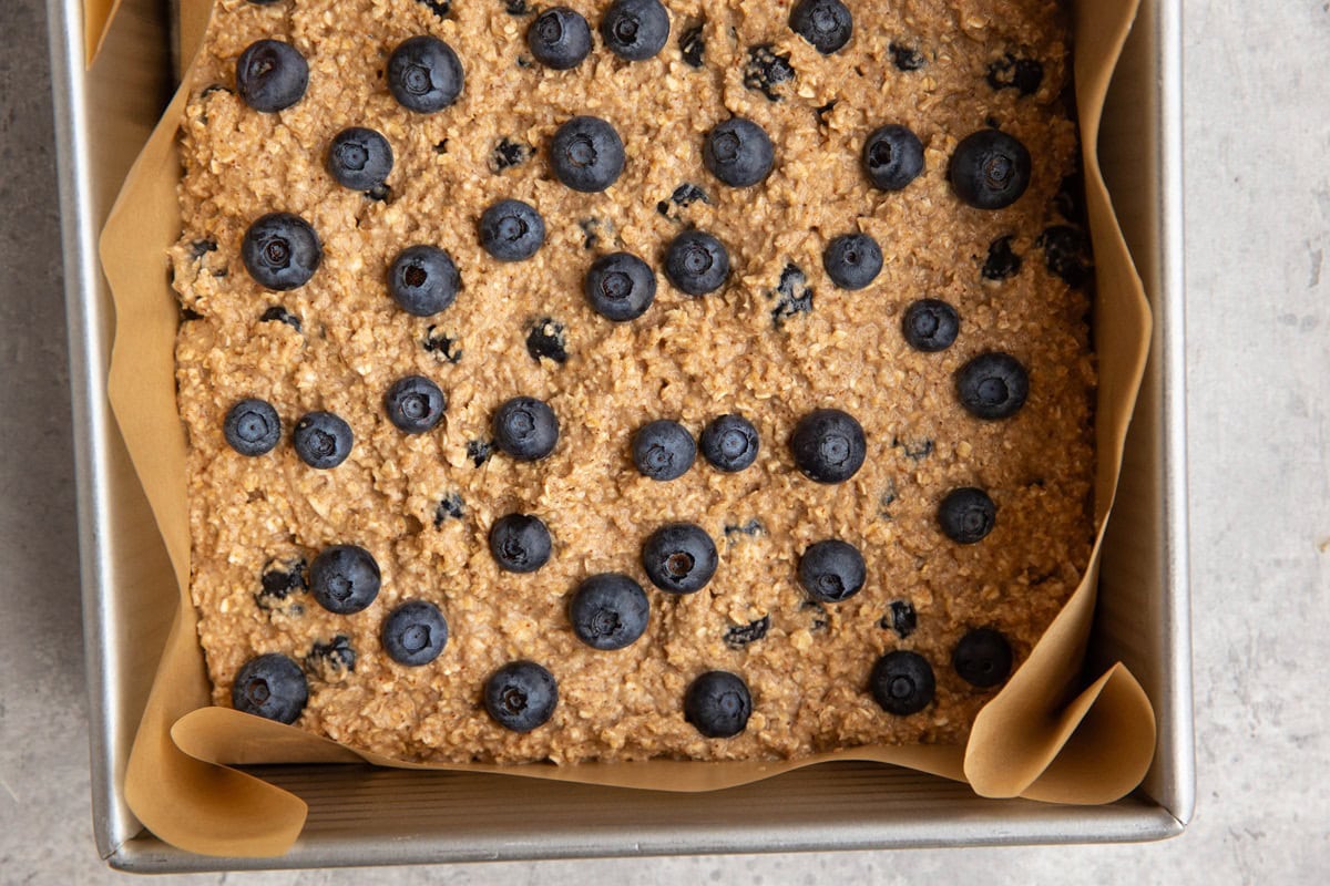 Square pan with oatmeal blueberry bars ready to go into the oven.