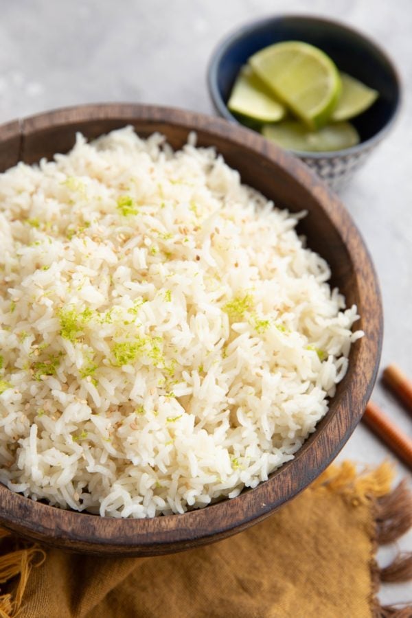 Wooden bowl full of coconut lime rice.