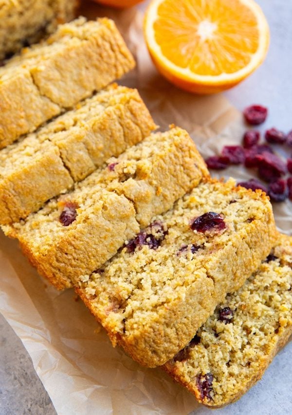 Loaf of cranberry orange bread cut into slices.