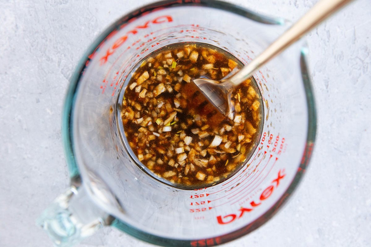 Steak bite marinade in a measuring cup.