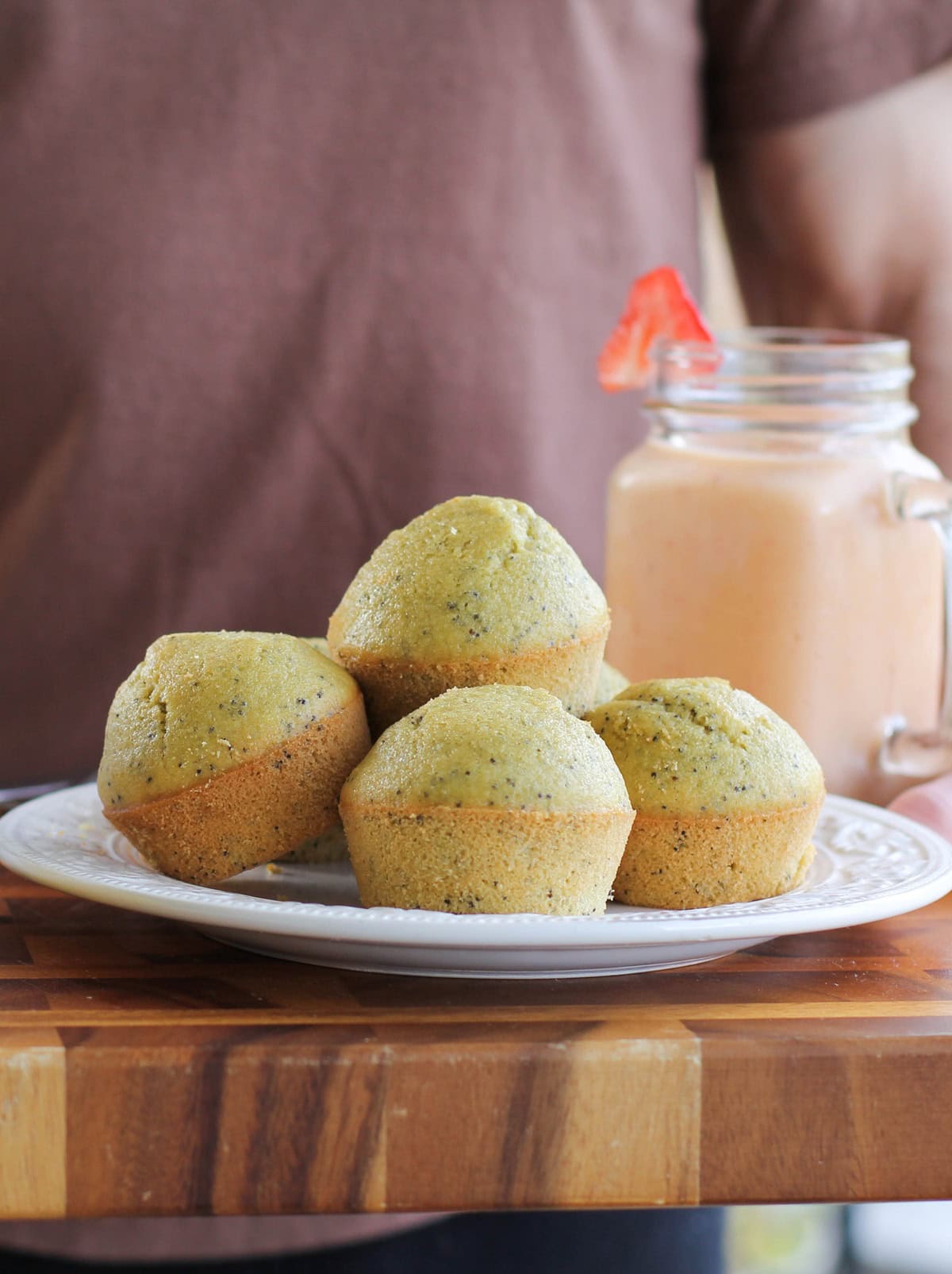 Plate full of lemon poppy seed muffins.