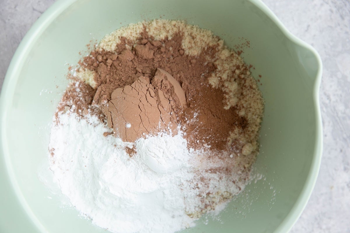 Mixing bowl full of almond flour, cocoa powder, tapioca flour, baking powder, and sea salt.