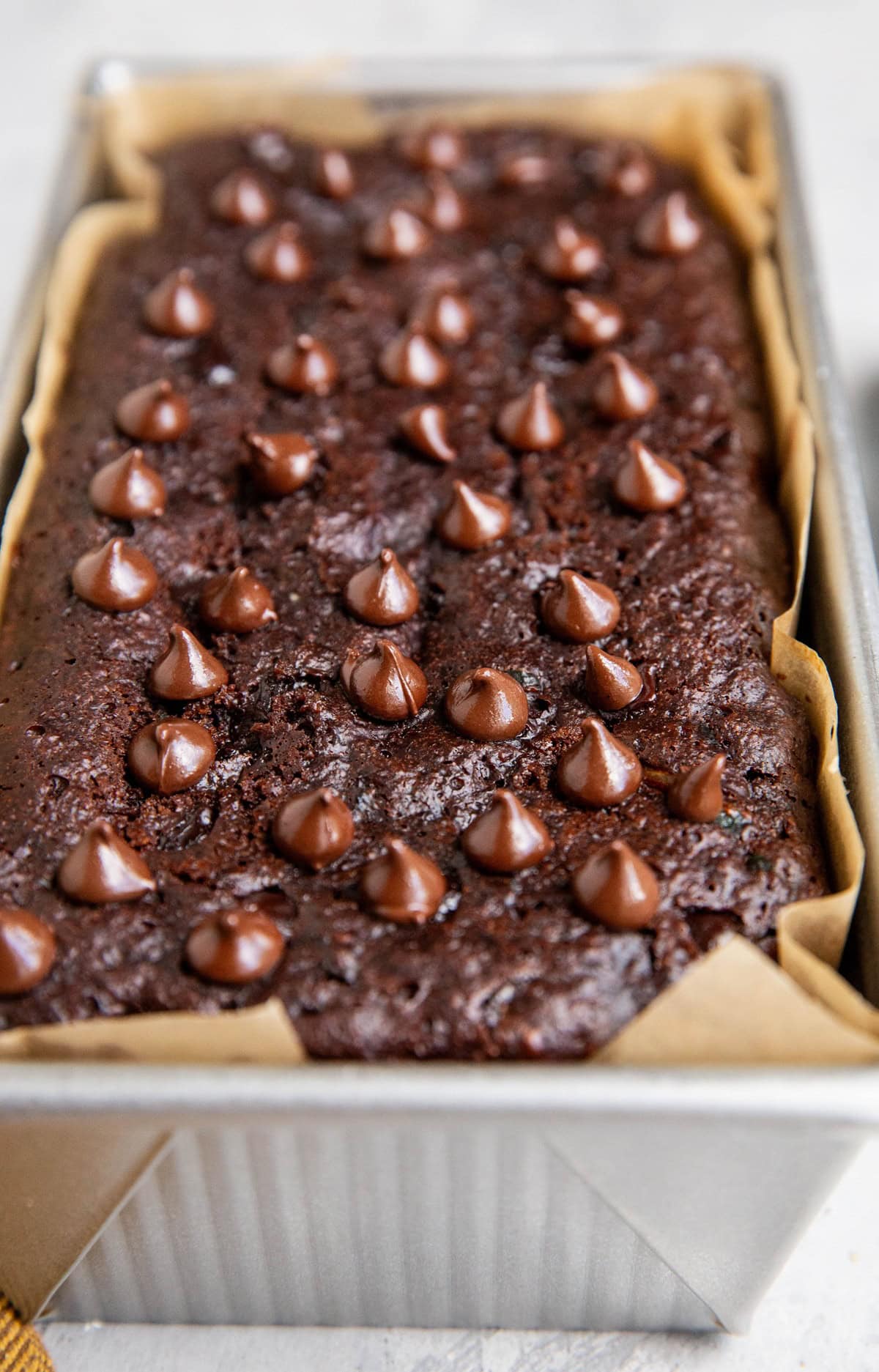 Loaf pan of almond flour chocolate bread, fresh out of the oven.