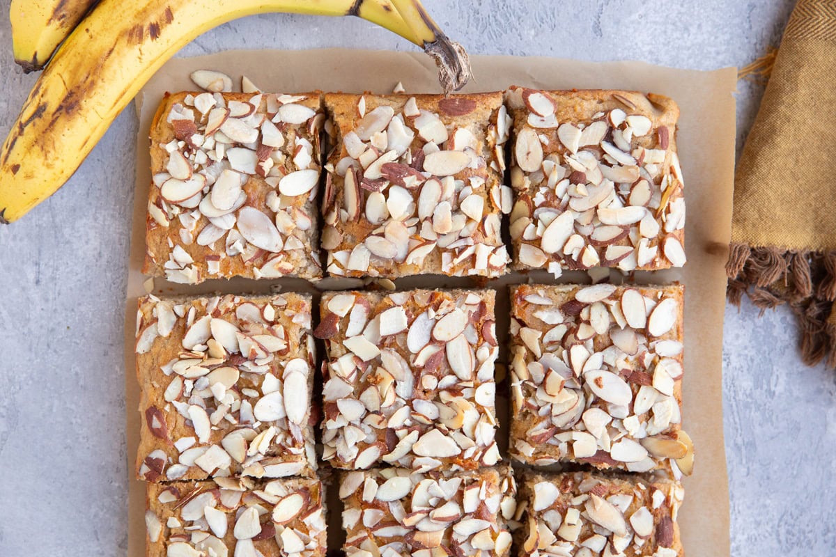 Cake on a sheet of parchment paper cut into individual portions.