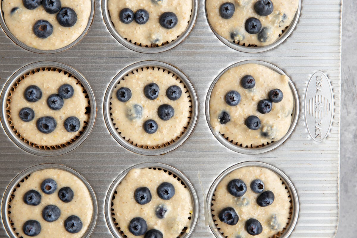 Muffin batter in a muffin tin, ready to go into the oven.