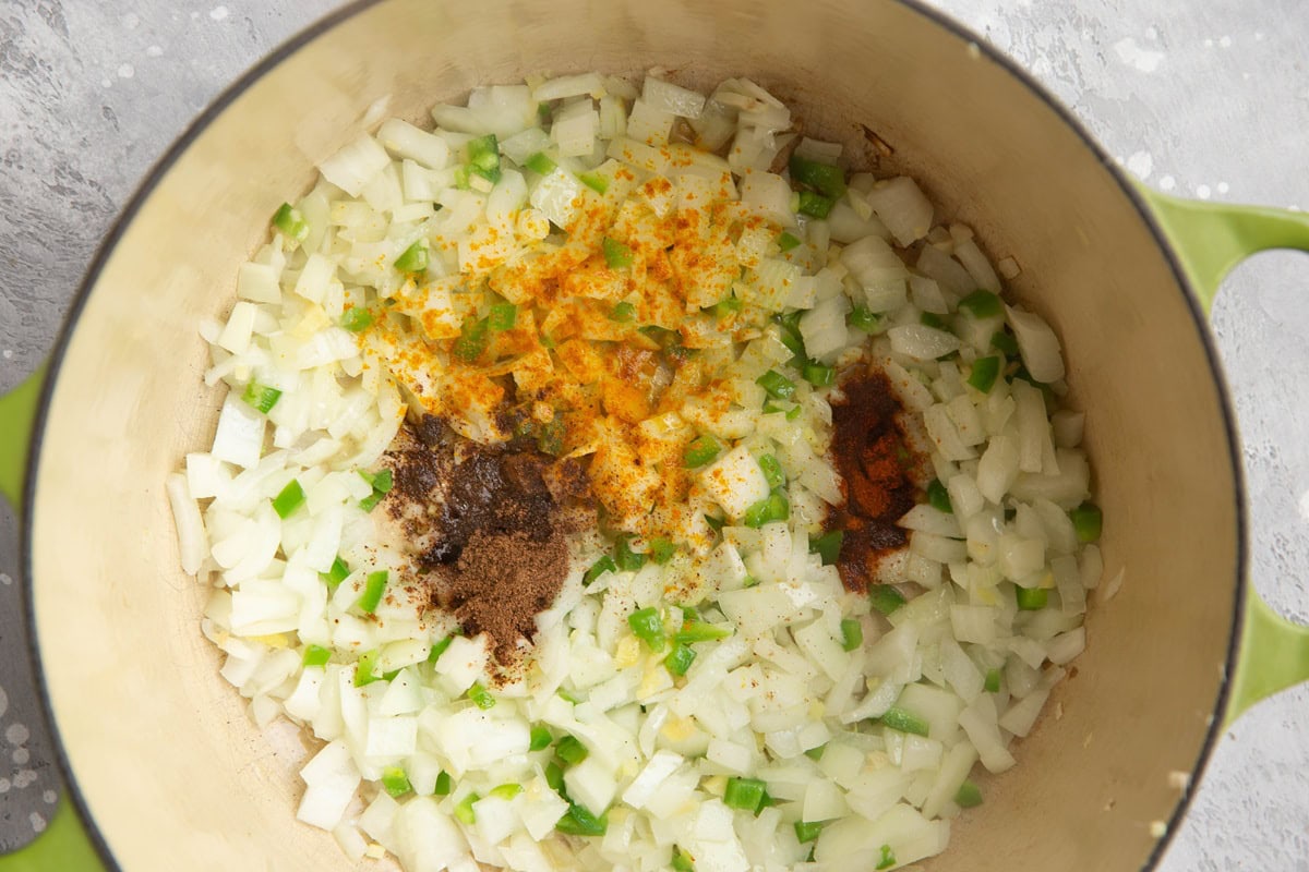 Onions, seasonings, chilis and garlic cooking in a large pot.