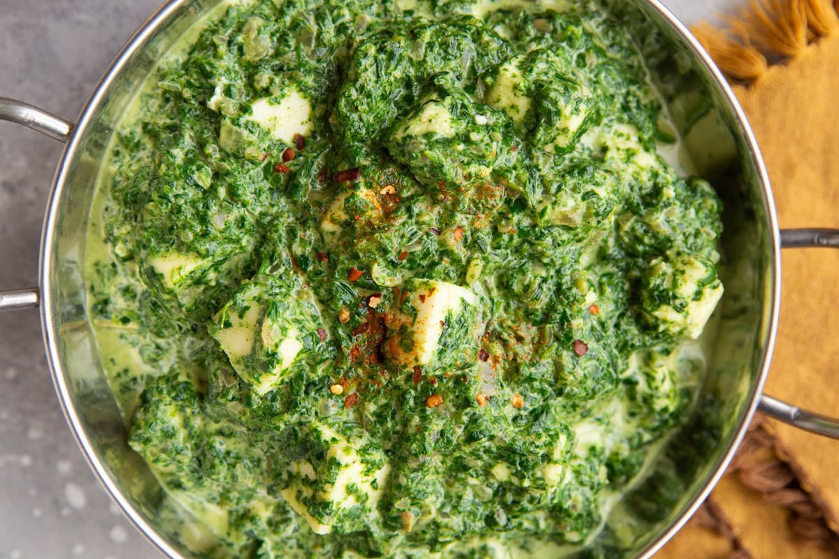 Indian dish full of Saag Paneer.