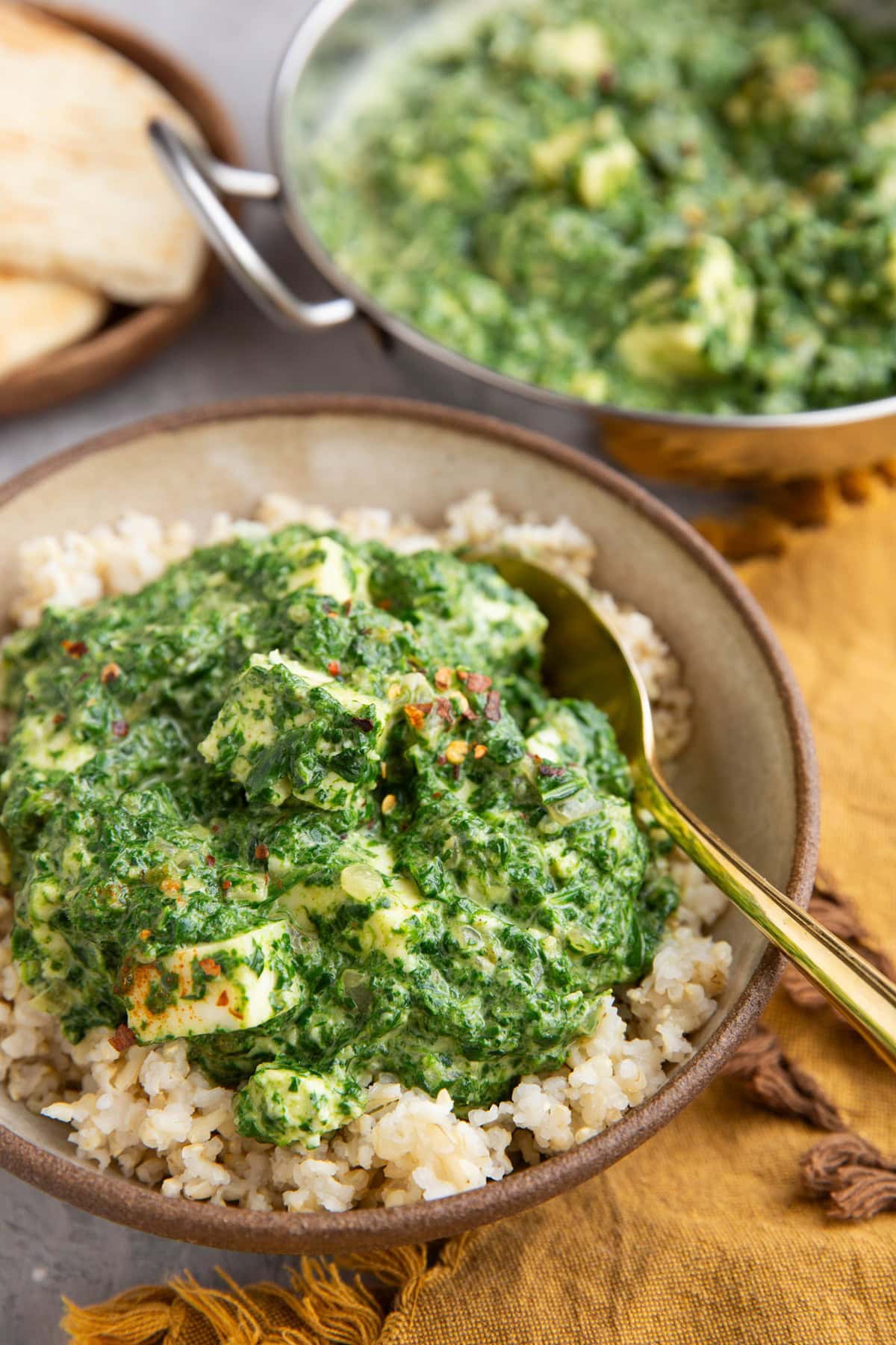 Saag Paneer in a bowl with steamed brown rice.