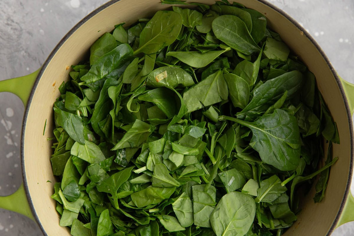 Chopped spinach in a large pot.