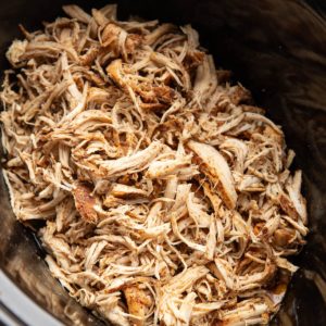 slow cooker full of shredded chicken, ready to use.