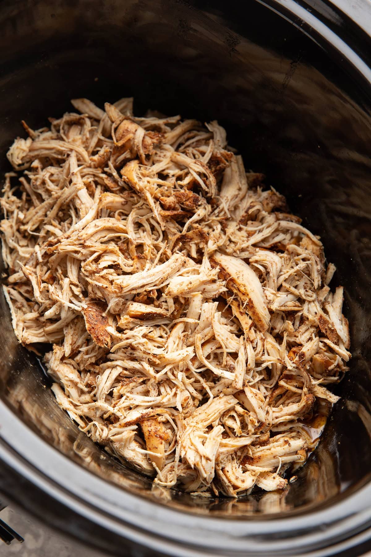 slow cooker full of shredded chicken, ready to use.